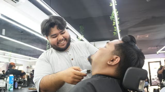 Barber trimming a beard